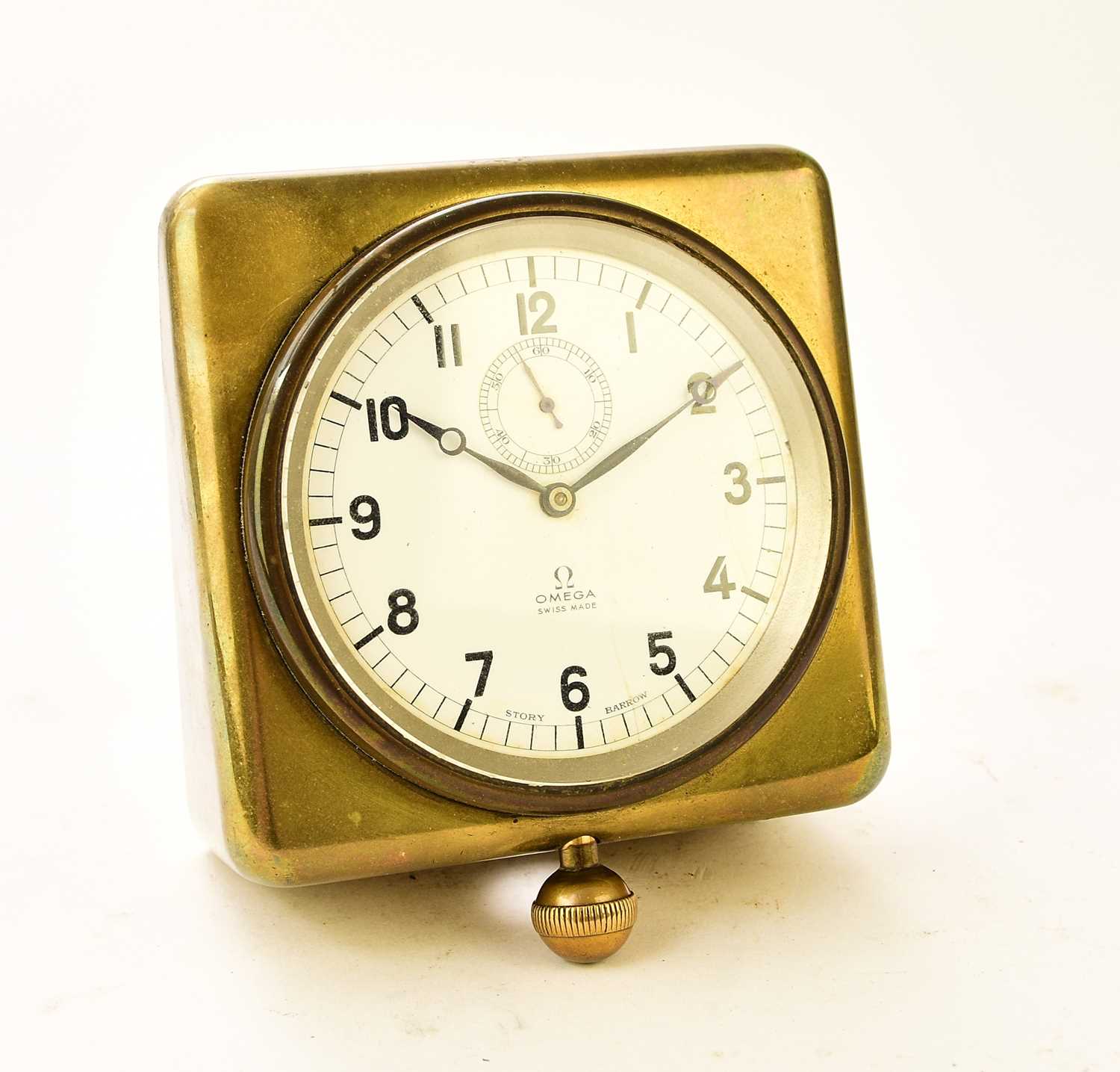 Lot 604 - An Omega brass-mounted car clock