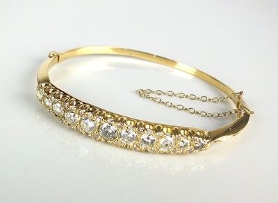 Lot 130 - A Victorian style diamond set hinged bangle