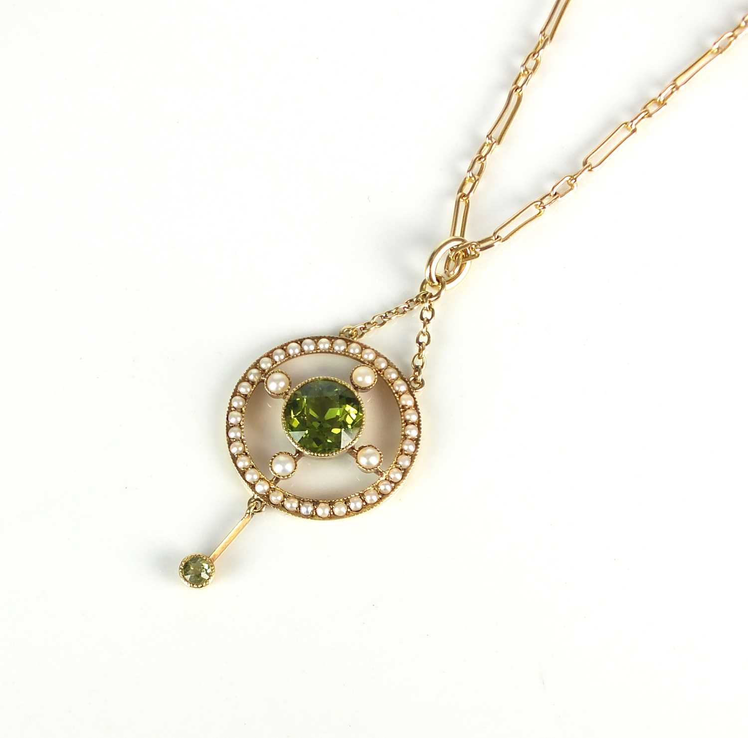 Lot 19 - An early 20th century peridot and seed pearl pendant on chain
