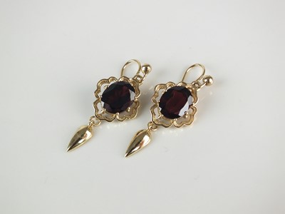 Lot 285 - A pair of yellow metal garnet ear pendants