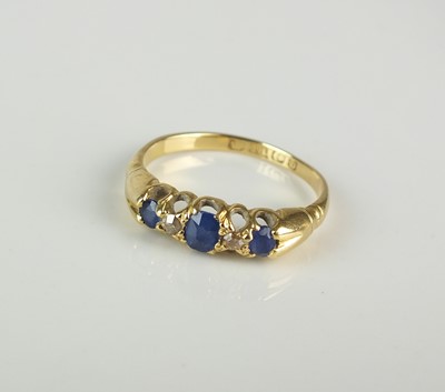 Lot 338 - An 18ct gold five stone sapphire and diamond ring