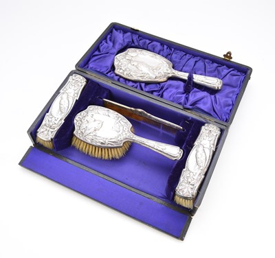 Lot 68 - An Edwardian cased silver mounted dressing table set