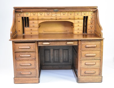 Lot 344 - A 20th century oak roll-top pedestal desk