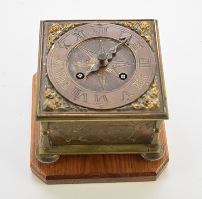 Lot 647 - A reproduction brass horizontal table clock