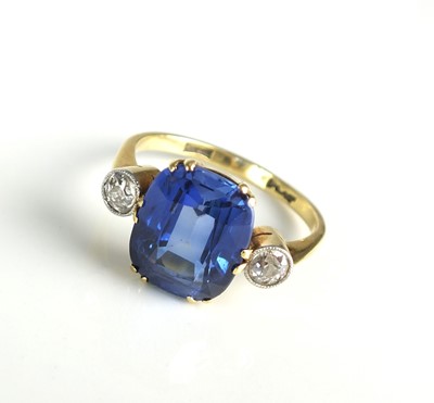 Lot 93 - A three stone synthetic sapphire and diamond ring