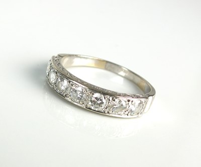 Lot 259 - A seven stone diamond half eternity ring