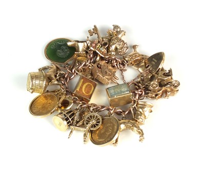 Lot 55 - A 9ct gold charm bracelet with attached charms