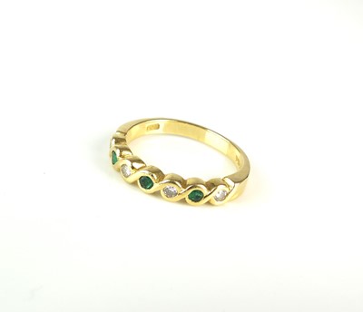 Lot 272 - An 18ct gold seven stone emerald and diamond ring