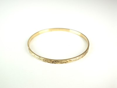 Lot 231 - A 9ct gold textured bangle