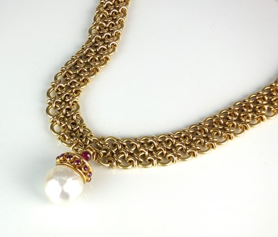 Lot 78 - An 18ct gold necklace with baroque cultured pearl and ruby pendant