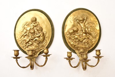 Lot 574 - A pair of reproduction cast brass candle sconces