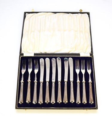 Lot 32 - A cased set of twelve silver handled fruit knives and forks