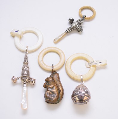 Lot 136 - A collection of four novelty rattles