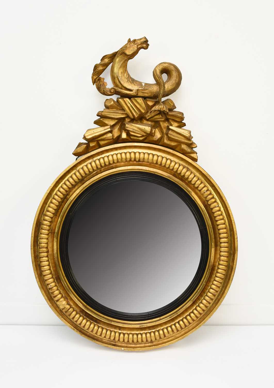 Lot 210 - A Regency giltwood and parcel ebonised convex mirror