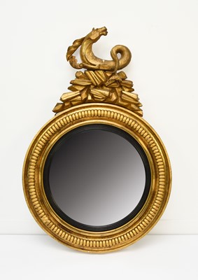 Lot 210 - A Regency giltwood and parcel ebonised convex mirror