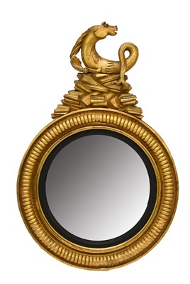 Lot 212 - A Regency giltwood and parcel ebonised convex mirror