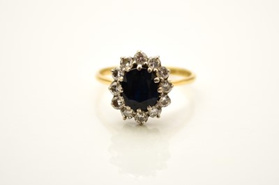 Lot 178 - A sapphire and diamond oval cluster ring