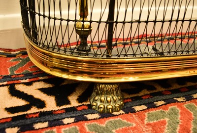 Lot 551 - A 19th century brass fire fender and accessories
