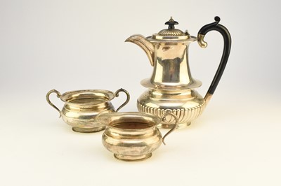 Lot 2 - A white metal hot water jug, together with a cream jug and sugar bowl