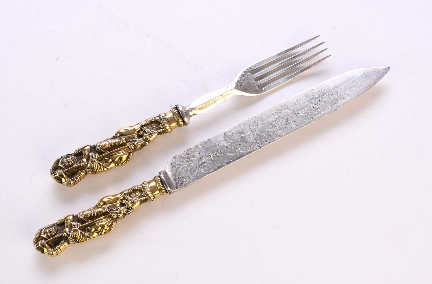 Lot 116 - A white metal and gilt metal 'George and Dragon' knife and fork