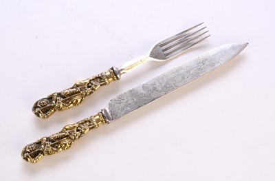 Lot 116 - A white metal and gilt metal 'George and Dragon' knife and fork