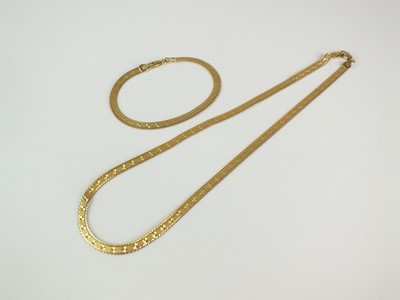 Lot 318 - A yellow metal flat link necklace chain and bracelet