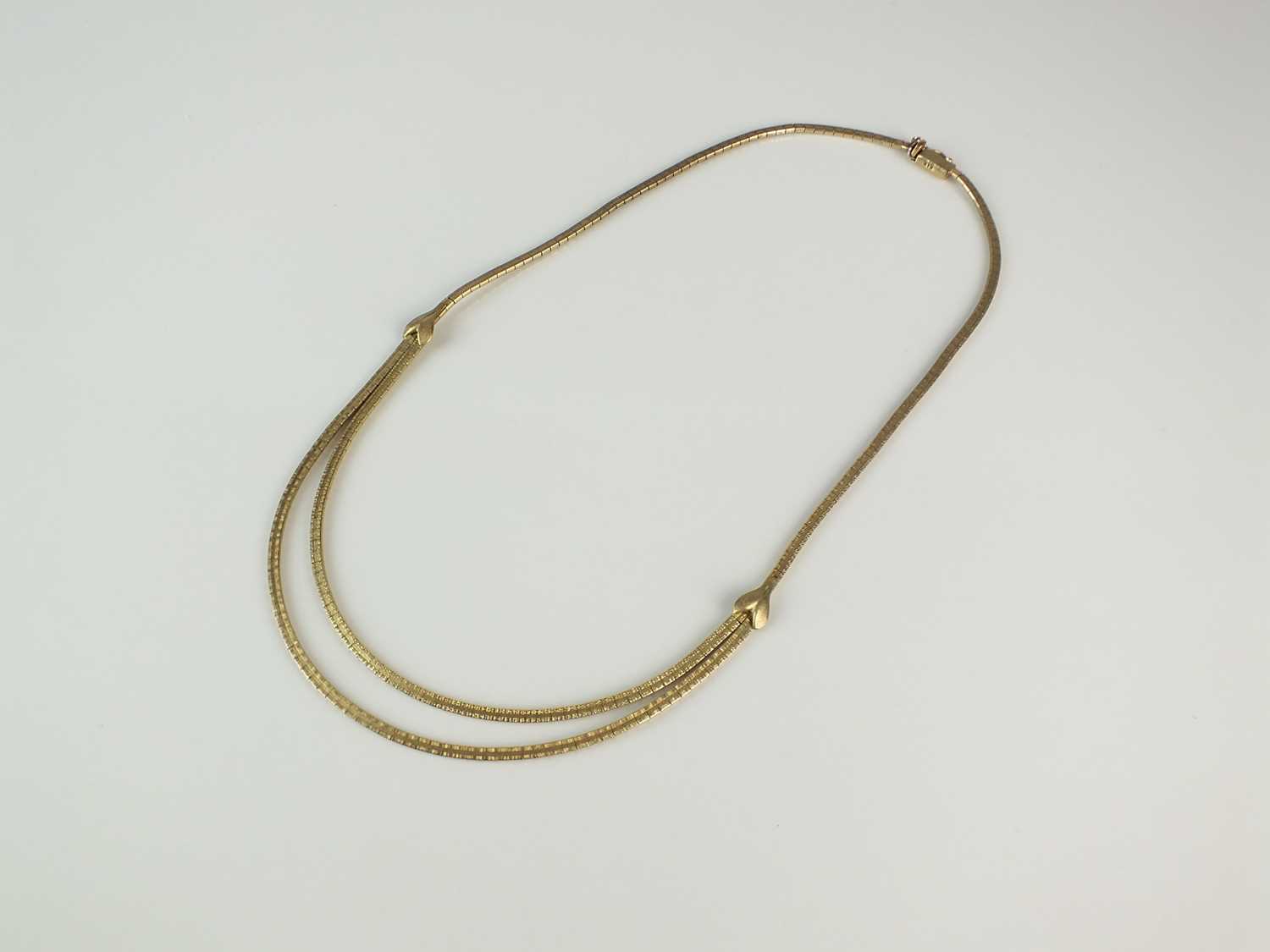 Lot 365 - A yellow metal two strand textured brick link necklace