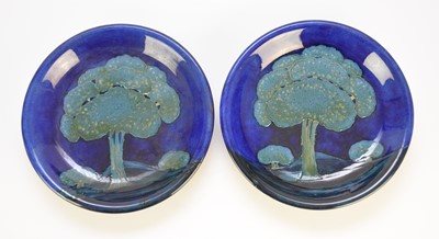 Lot 258 - A near pair of William Moorcroft 'Moonlit Blue' plates, circa 1925