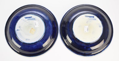 Lot 258 - A near pair of William Moorcroft 'Moonlit Blue' plates, circa 1925