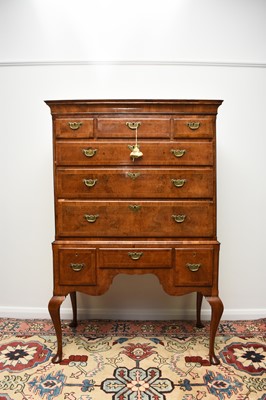 Lot 181 - A George II cross-banded and feather-banded walnut chest on stand