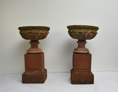 Lot 220 - A pair of buff terracotta garden urns on associated pedestal bases