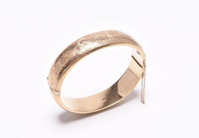 Lot 220 - A 9ct gold hinged bangle