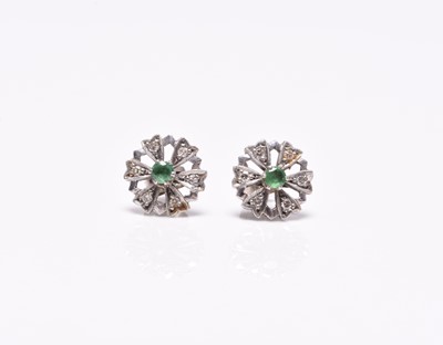 Lot 387 - A pair of emerald and diamond floral cluster earrings