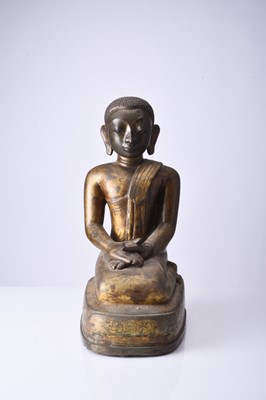 Lot 90 - A Burmese gilt bronze figure of a seated monk, late Qing Dynasty
