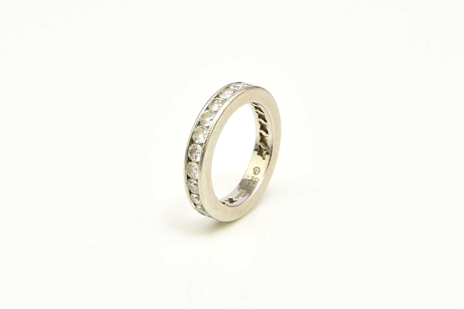 Lot 27 - A De Beers platinum diamond full eternity ring