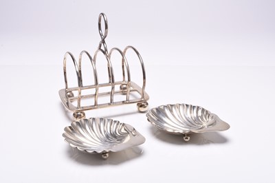 Lot 142 - A silver four division toast rack and two silver shell dishes