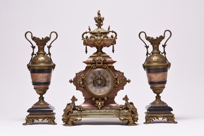 Lot 216 - A French gilt metal and pink marble mantel clock garniture