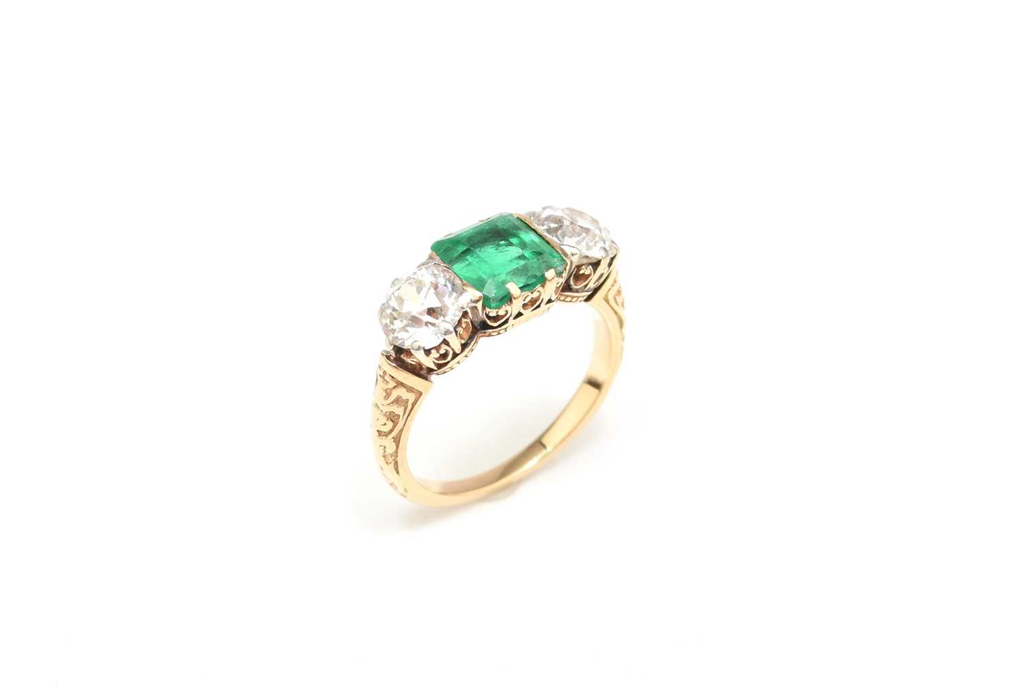 37 - A late 19th / early 20th century three stone emerald and diamond ring