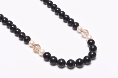 Lot 93 - A rutilated quartz, cultured pearl and black bead necklace