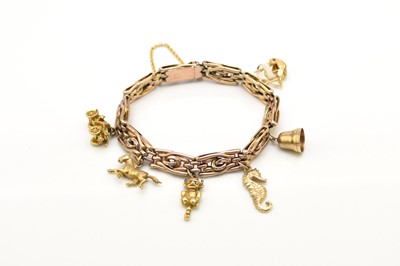 Lot 40 - A rose metal decorative link bracelet with attached charms