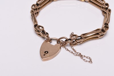 Lot 244 - A yellow metal three bar gate link bracelet