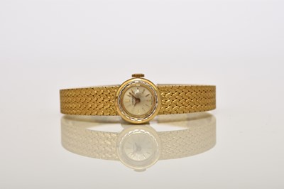 Lot 58 - Longines: A lady's 18ct gold bracelet watch