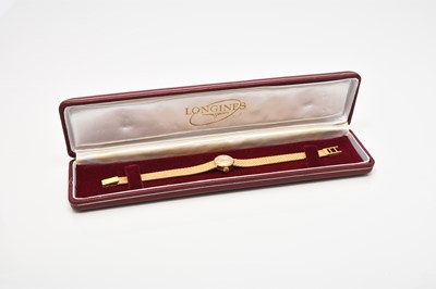 Lot 58 - Longines: A lady's 18ct gold bracelet watch