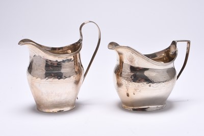 Lot 67 - Two George III silver helmet cream jugs