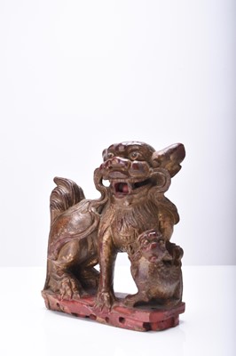 Lot 117 - A Chinese carved and painted wood figure of a guardian lion, Qing Dynasty