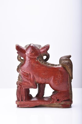 Lot 117 - A Chinese carved and painted wood figure of a guardian lion, Qing Dynasty