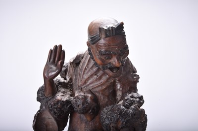 Lot 132 - Three Chinese carved wood figures of Luohan, Qing Dynasty