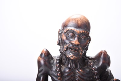 Lot 132 - Three Chinese carved wood figures of Luohan, Qing Dynasty