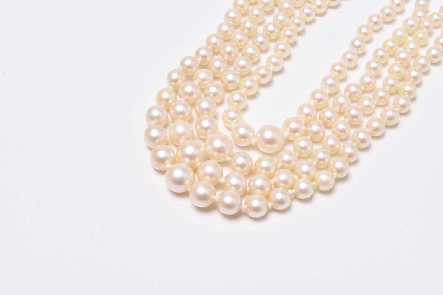 Lot 345 - A four strand graduated cultured pearl necklace with 18ct white gold diamond set clasp