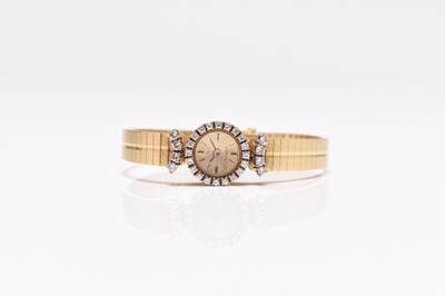 Lot 100 - Omega: A lady's 18ct gold diamond set bracelet watch